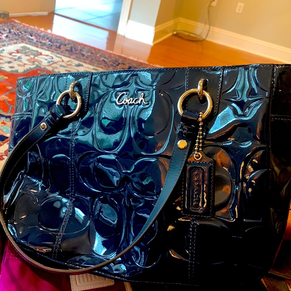 Coach patent leather navy bag. Double handle very roomy, inside zippered pocket.